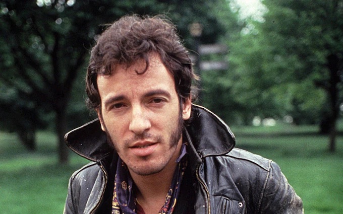Bruce Springsteen in leather jacket with collar up