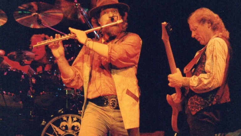 Ian Anderson and Martin Barre of Jethro Tull on stage, playing flute and guitar respectively.