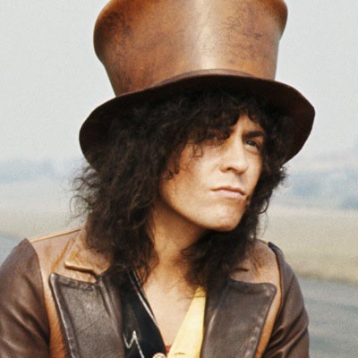 Headshot of Marc Bolan wearing a brown top hat.