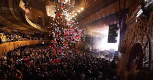 New York's Beacon Theater during a New Years show with falling balloons.
