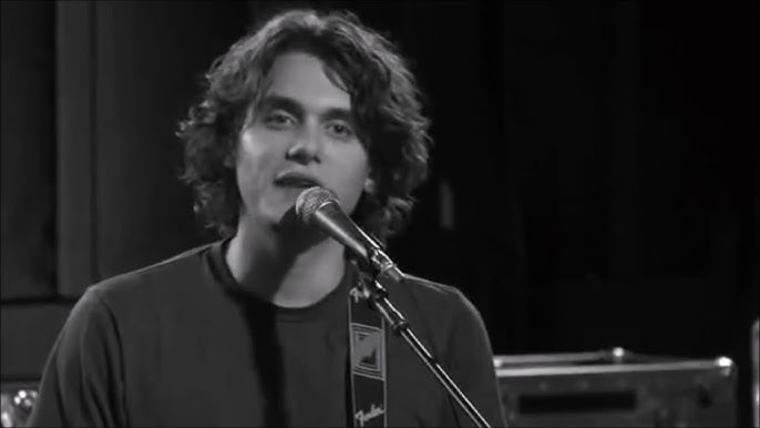Singer / guitarist John Mayer at microphone