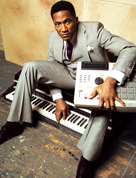 Hip-Hop artist Q-Tip seated with mixer