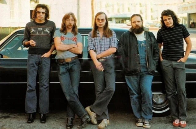 Group shot of Steely Dan in front of car