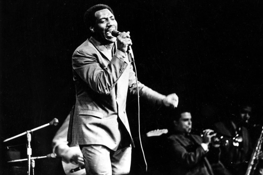 Singer Otis Redding on stage singing