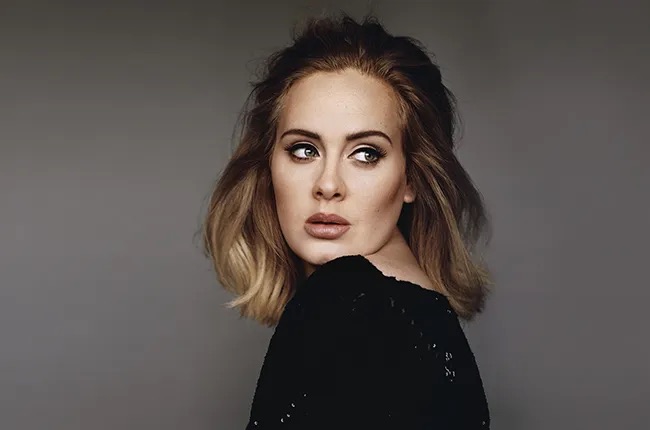 Singer Adele from side with head over shoulder