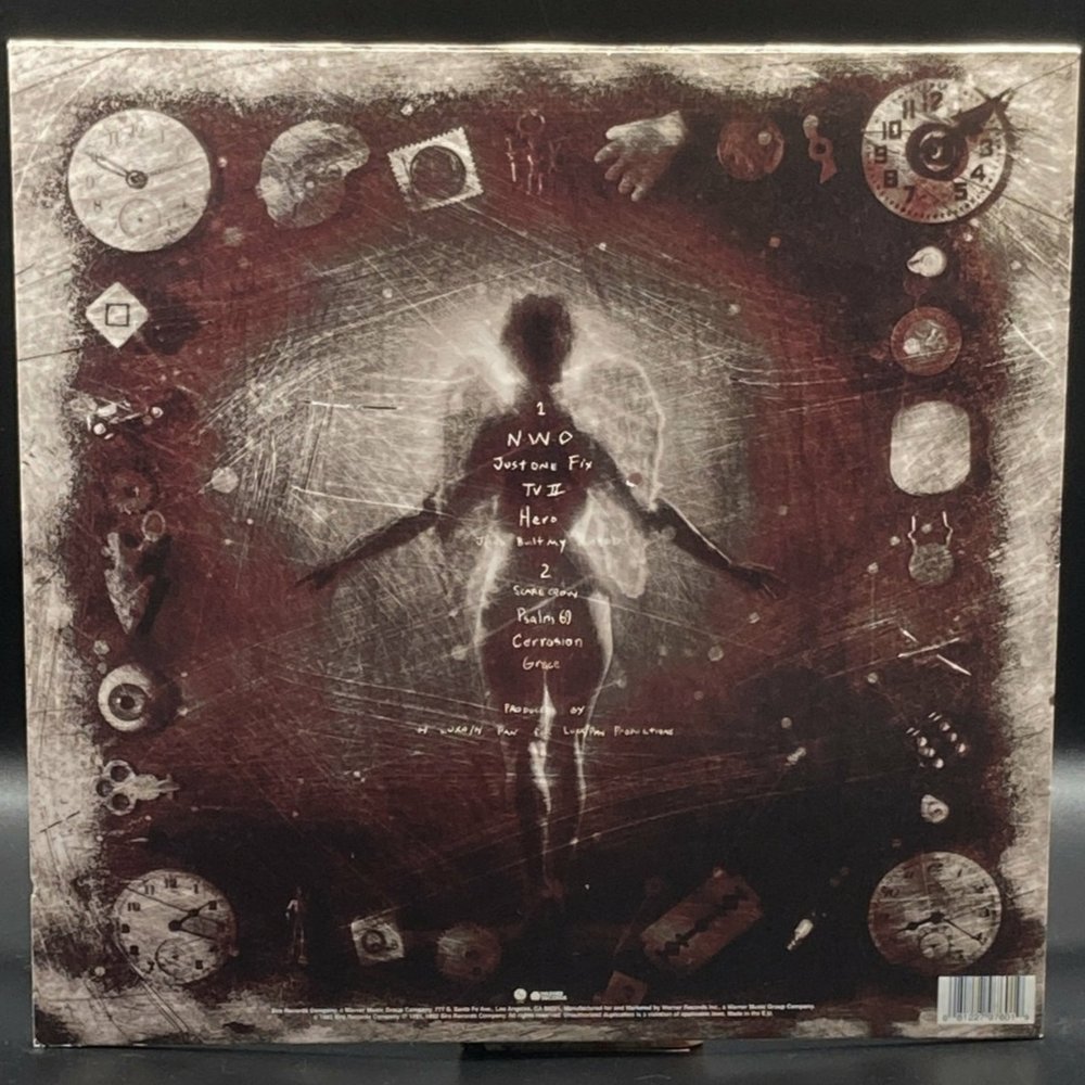 The cover of the Ministry album ΚΕΦΑΛΗΞΘ (Psalm 69) which is a winged figure surrounded by various objects.