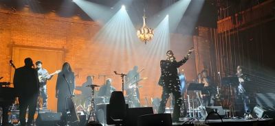 Poi Dog Pondering on lighted stage