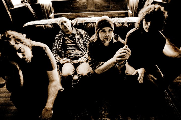 Group shot of the band The Blizzard of 78 with members seated on a couch