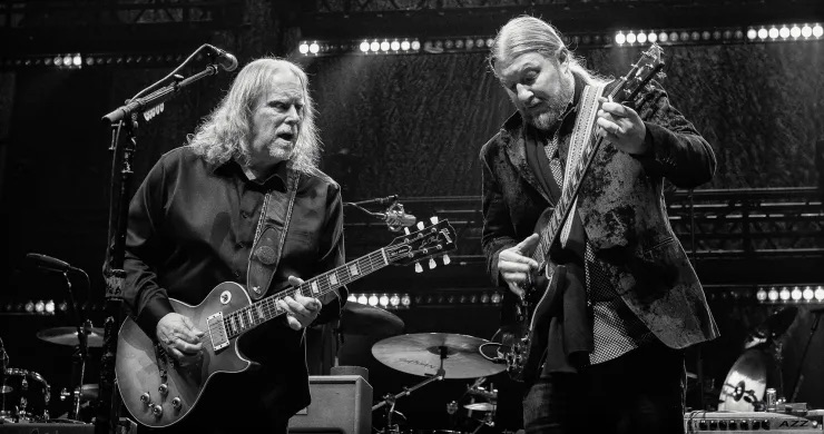 Warren Haynes and Derek Trucks on stage playing electric guitars