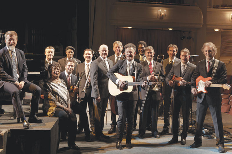 Lyle Lovett with guitar in a group shot with his appropriately named Large Band