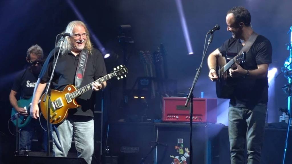 Photo of Warren Haynes - left and Dave Matthews - Right on stage with guitars in hand