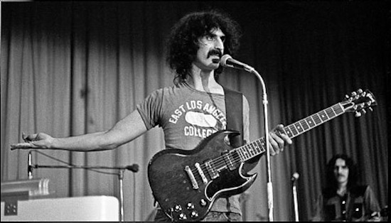 Frank Zappa on stage holding Gibson SG guitar