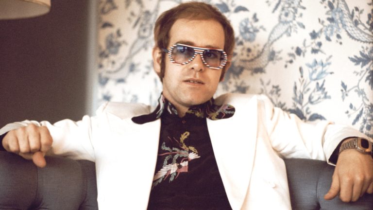 Elton John relaxing on couch