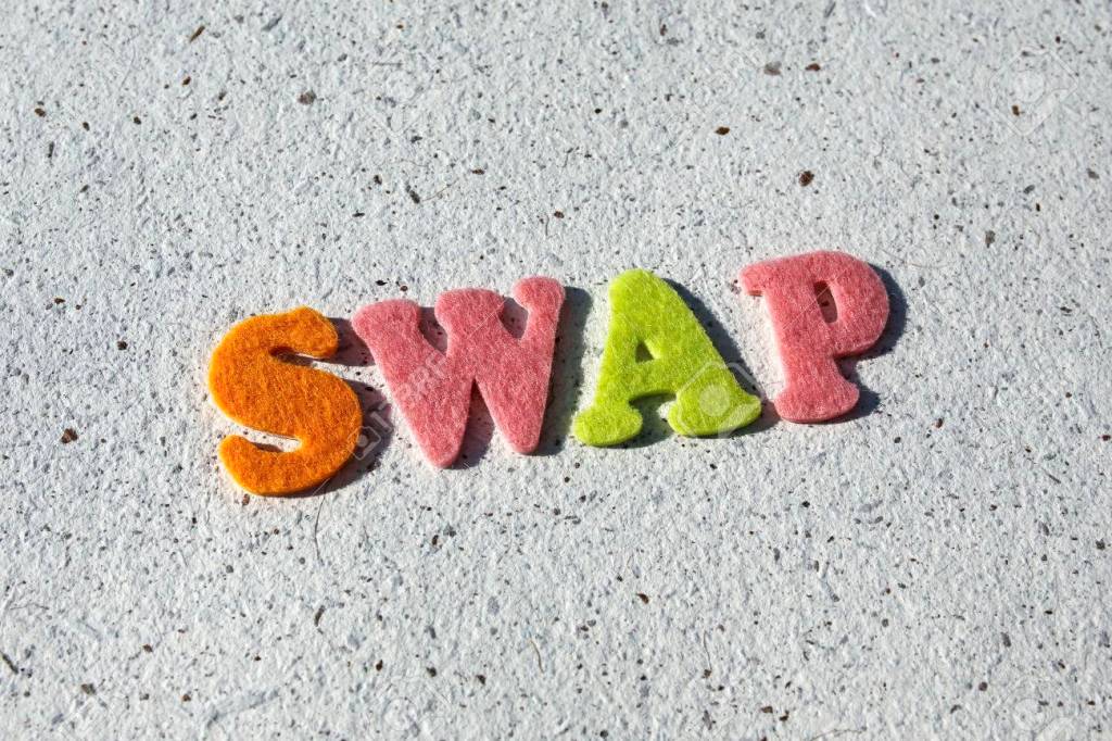 Plastic letters forming the word SWAP on a textured background.