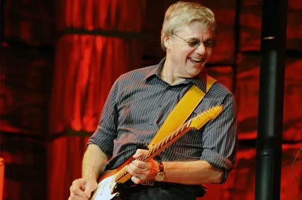 Steve Miller on stage playing electric guitar