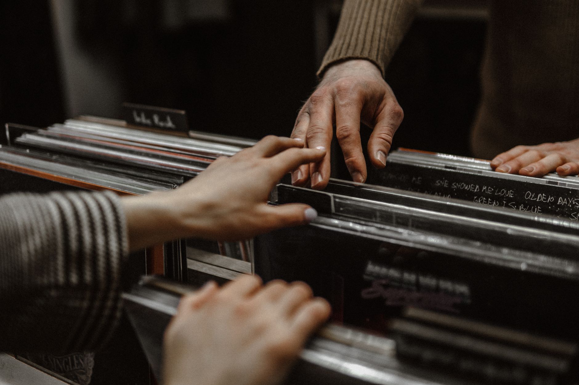 hands touching while browsing posters